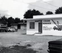 A black and white photo of the Hampton crane service.