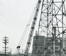 A vintage black and white photo of a construction crane.